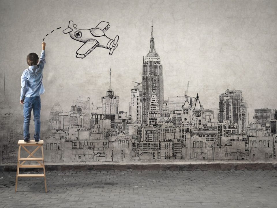 Little boy drawing on a wall